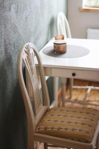 a table with two chairs and a white table with a table and a table at Apartaments Nr.33 (Viesu Nr.3) in Talsi