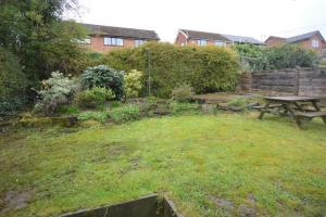 a garden with a picnic table in the grass at Lovely 3 bedroom house in Romiley, Stockport with parking for 3 cars in Romiley