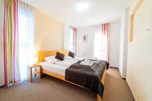 Postel nebo postele na pokoji v ubytování Aparthotel Belveder