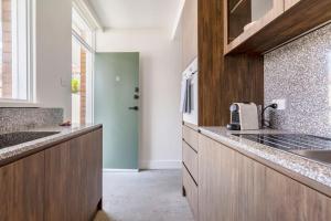 a kitchen with a sink and a counter top at Walk to everything Carlton has to offer in Melbourne