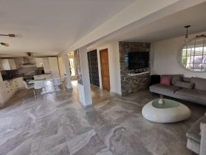a large living room with a couch and a table at Villa avec vue entre Mer et Lac in Ampus