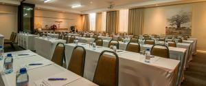 a row of tables and chairs in a room at The Graham Hotel in Grahamstown