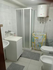 a bathroom with a shower and a toilet and a sink at Casa Agatina in Catania