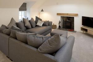 a living room with a couch and a fireplace at Stroan in New Galloway
