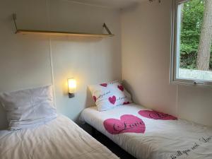 a small room with two beds with hearts on them at Vakantiepark Breebos in Rijkevorsel +82 photos