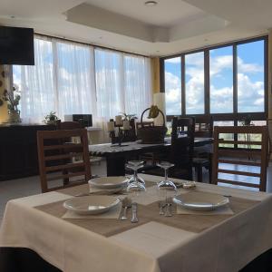 a dining room table with a white table cloth and glasses at Paradiso Country House in Pescara