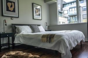 a bedroom with a bed and a large window at Charming Duplex in Grand Canal in Dublin