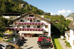 a building with cars parked in front of it at Pension Alpenrose in Zell am See