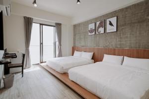 Postel nebo postele na pokoji v ubytování Huiwei B&B