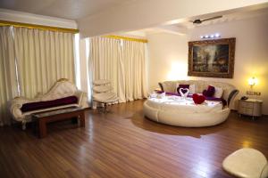 a living room with a couch and a table at White Pearl Suites by Rosetum in Old Goa