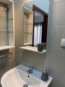 a bathroom with a sink and a mirror at Platan 17 in Świnoujście