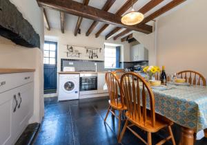 a kitchen with a table and chairs and a laundry room at Ty Newydd in Dolgellau