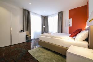 a hotel room with two beds in a room at Boutique Hotel Piazza Grande Locarno - Easy Self Check-In in Locarno +42 photos