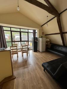 a living room with a couch and a table and chairs at Albergue de peregrinos Compostela in Molinaseca