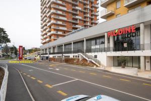 an empty street in front of a building at Mannequin: Sea view, private parking in the garage in Rijeka