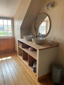a bathroom with two sinks and a mirror at La Villa L'Escale in Audresselles