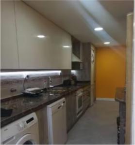 a kitchen with a sink and a stove top oven at HABITACION INDIVIDUAL in Valencia