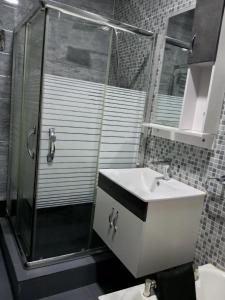 a bathroom with a sink and a shower at The Niche Homes & Apartments in Ikoyi +4 photos
