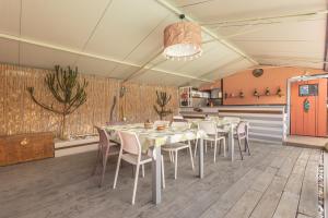 a dining room with a table and chairs in it at Veggia Butega in Diano San Pietro