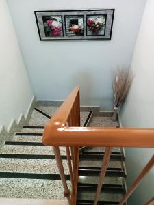 a staircase with a bench and two pictures on the wall at Hotel Alma Rosa in Navaluenga