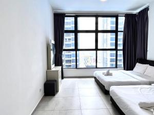 a hotel room with two beds and a large window at Golden House-Atlantis Residence in Malacca