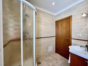 a bathroom with a shower and a sink at Carvoeiro Terrace by Homing in Carvoeiro