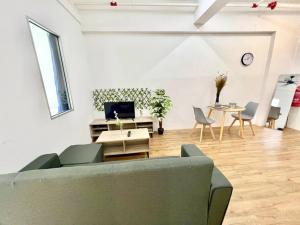 a living room with a couch and a table at G2 1-8Paxs Cozy Home Sunway Medical Geo SmrtTV 3bed in Kampong Penaga