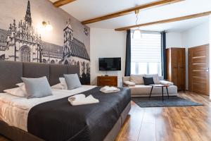 a bedroom with two beds and a couch and a tv at Boutique Penzion Slovakia & Slovakia Residence in Košice