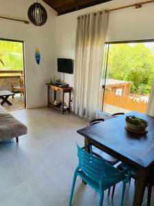a living room with a table and chairs and a television at Reserva Eco Itacimirim in Camaçari