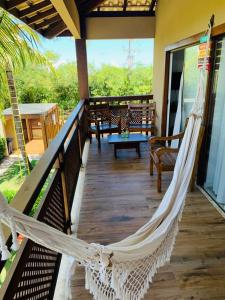 a hammock on the porch of a house at Reserva Eco Itacimirim in Camaçari