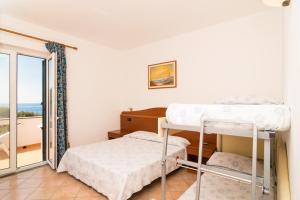 Postel nebo postele na pokoji v ubytování Hotel Villa Fumerie
