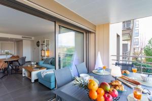 - un salon avec une table et des fruits dans l'établissement A7- 2 bdr partial sea view AC parking terrace pool, à Antibes