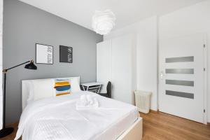 Voodi või voodid majutusasutuse Obrzeżna Comfort Apartment toas