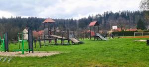 a park with a playground with slides and play equipment at Apartament KARO 1 Karkonosze in Jelenia Góra