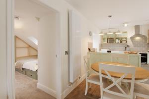 a kitchen and a bedroom with a table and a bed at Skerrow in New Galloway +11 photos