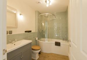 a bathroom with a tub and a toilet and a sink at Skerrow in New Galloway