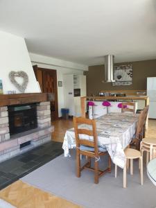 a dining room with a table and chairs and a fireplace at La Tour de l'Ill in Strasbourg