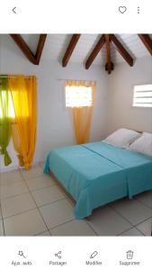 Postel nebo postele na pokoji v ubytování Appartement charmant à Petit-Canal