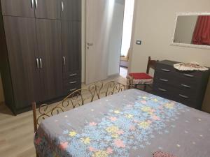 a bedroom with a bed and a dresser at 2 bedrooms apartement at Avola 150 m away from the beach with sea view enclosed garden and wifi in Avola