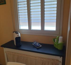 a kitchen counter with a window and aendar at 2 bedrooms apartement at Avola 150 m away from the beach with sea view enclosed garden and wifi in Avola
