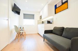 a living room with a couch and a table at Regents Serviced Apartments by StayPrime in London