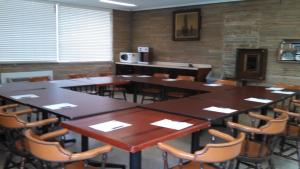a conference room with tables and chairs and a microwave at Mount Vernon Inn in Sumter
