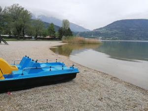 un barco azul sentado en la orilla de un lago en Ca' dei Cigni en Calceranica al Lago