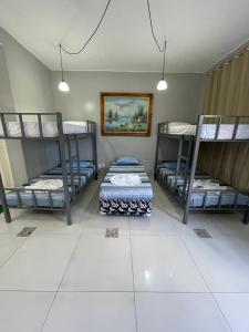 a room with three bunk beds in it at Aldeia Hostel II in Manaus