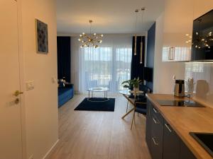 Una cocina y una sala con una mesa y un comedor. en Apartament przy Marsa, en Varsovia