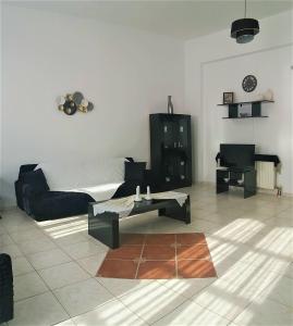 a living room with a couch and a coffee table at Akakia Residence - Vivlos Village in Vívlos