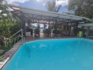 a pool with a pergola and a table and chairs at Mirella Villa Island Princess Villa in Praslin