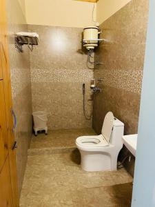 a bathroom with a toilet and a sink at Hotel Sarai Bharatgarh in Chandīgarh +94 photos