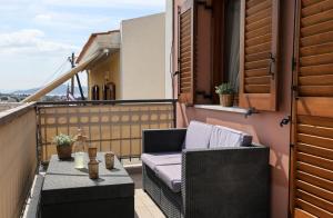 a balcony with a couch and a table on a balcony at Condo in Aegina in Egina
