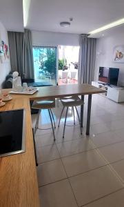 a kitchen with a large wooden table and two chairs at Casa Lidia Costa Calma beach in Costa Calma +33 photos